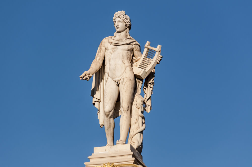 statue of Apollo against blue skies