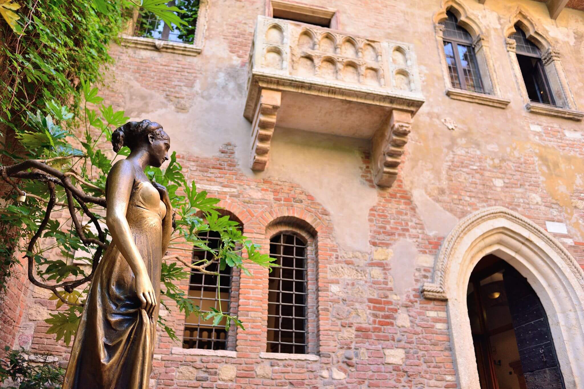 Statue of Juliet beside her balcony in Verona