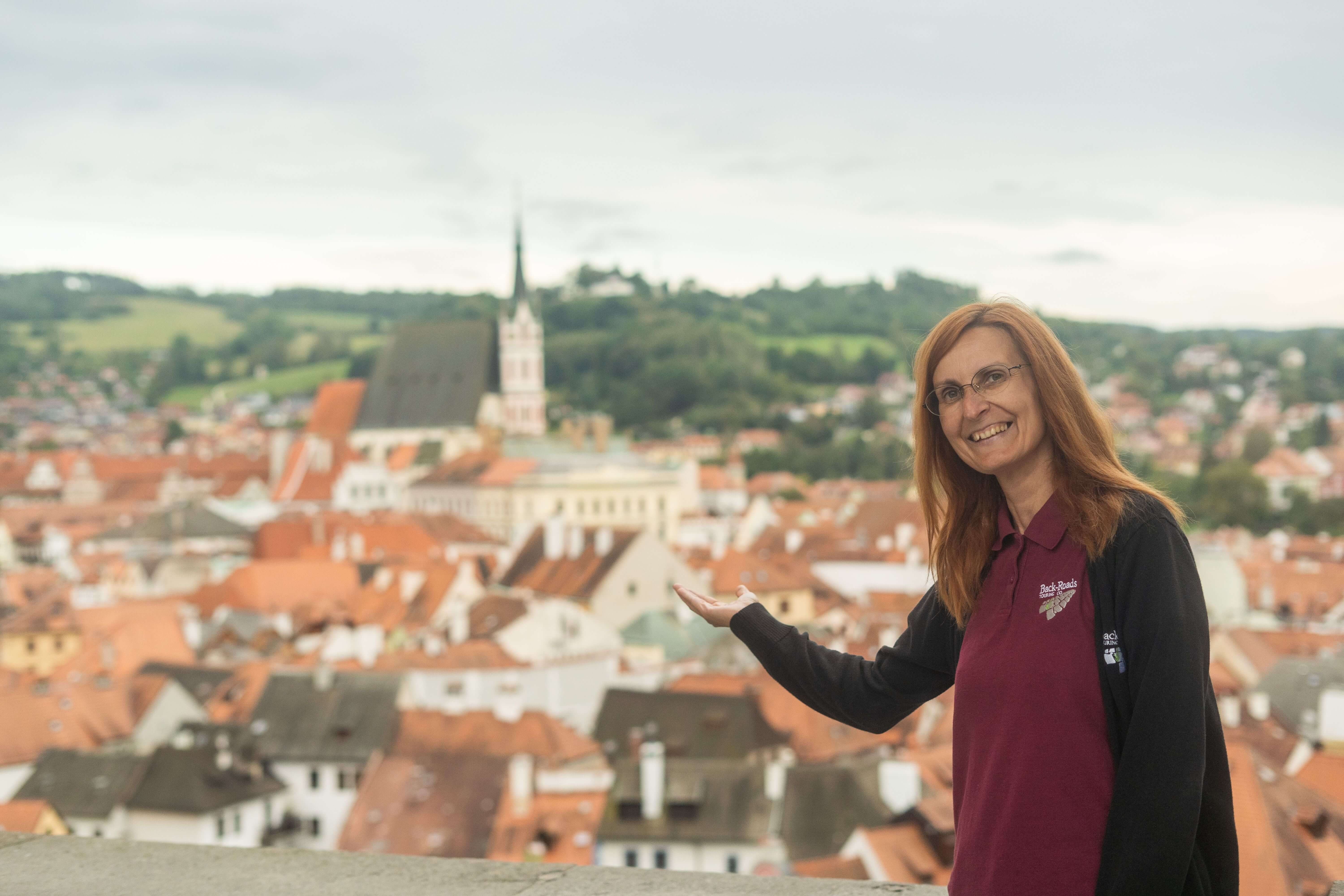 Local female Back-Roads Tour Leader overlooking a city