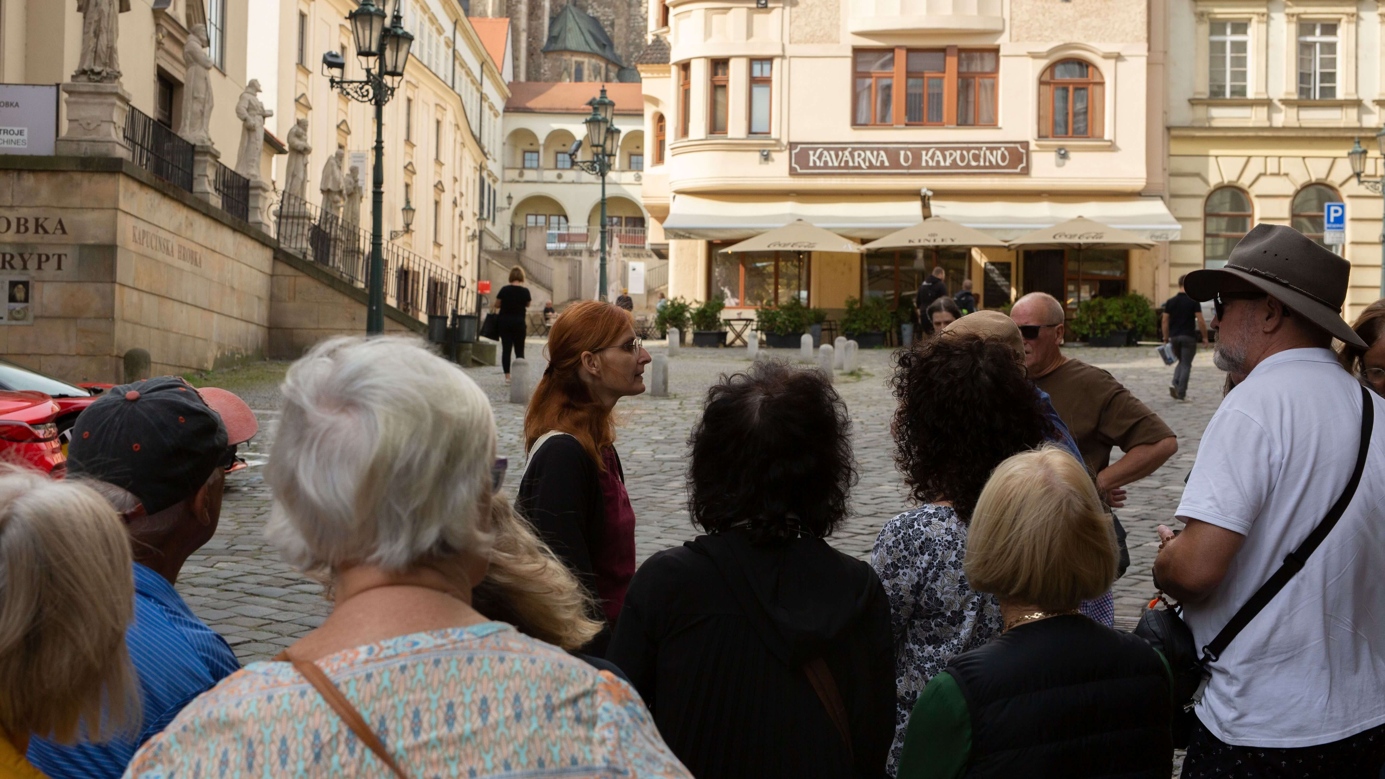 Local Tour Leader speaking to small group tour of mature adults during an orientation