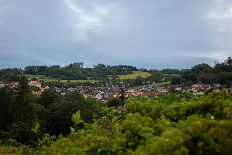 Landscape of green fields with Ceský Krumlov in distance