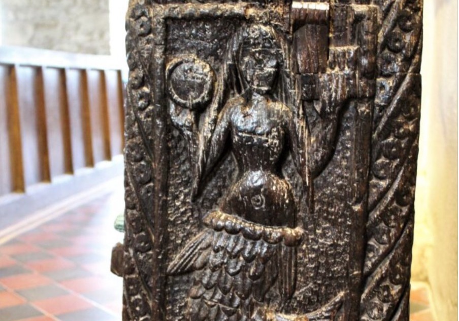 a wood carving of the Mermaid of Zennor on a chair in a Cornish church