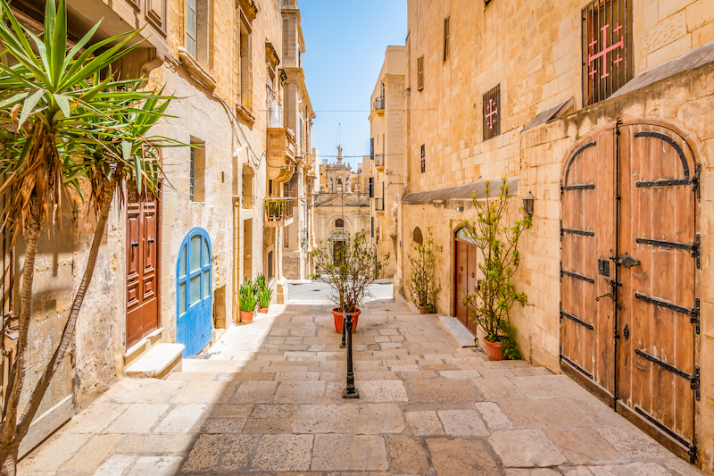 cobbled streets of Valletta, Malta, leading to a baroque church