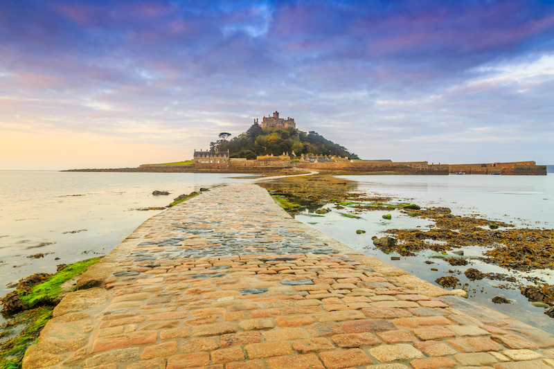 cobbled causeway leading to St Michael's Mount at low tide and sunset