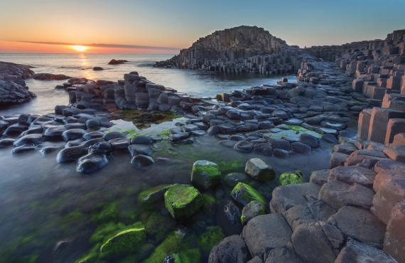 Rising tides during sunset at Giants Causeway in Northern Ireland.