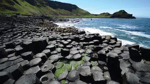 A view of the storied Giant's Causeway, its impossible basalt structures standing prominently amidst the waves.