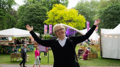 Traveller posing for the camera at the refreshment area of the Chelsea Flower Show.