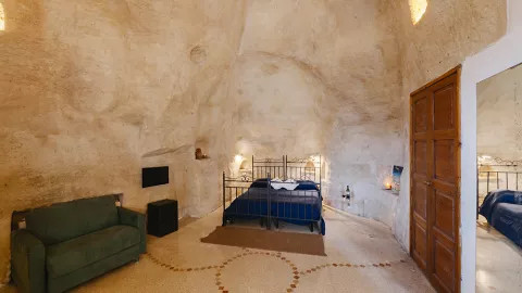 A view of a stone cave room in a rustic hotel.