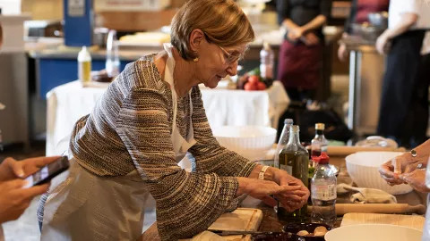 Travellers undertaking an Italian cooking class.