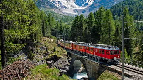 A view of the Bernina express, journeying through the Swiss Alps as it travels from Italy to Switzerland.