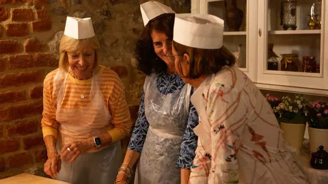 Travellers preparing for an Italian Cooking class experience during their tour of Tuscany.