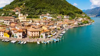 An aerial view of a small town on the coast of Lake Iseo.