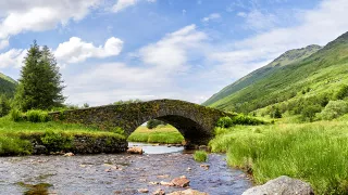 A view of the the Butter Bridge, a stone bridge in Glen Kinglas over a river leading to Loch Lomond.