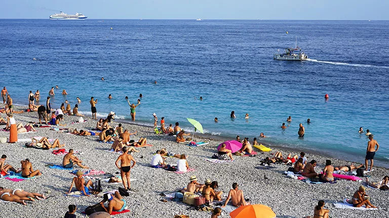 People sunbathing on a beach in Nice, France