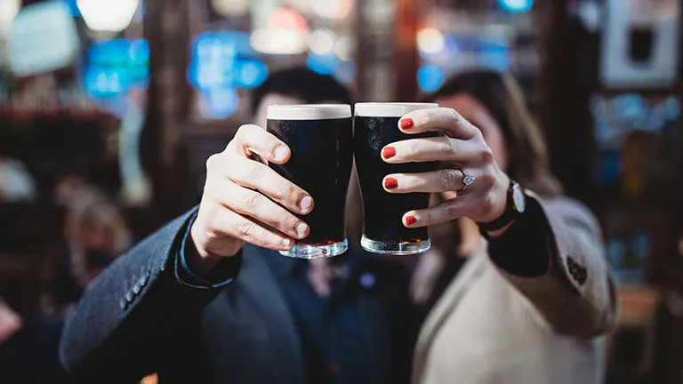 A couple enjoying a pint of Guinness in Dublin
