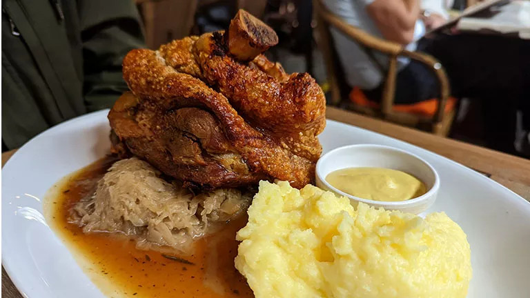 Traditional German dish of Pork knuckle, saurkraut and potatoes