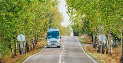 Tour bus going down a country road in France.