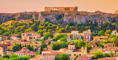 A view over Athens at dusk with the famous Acropolis looming in the background.