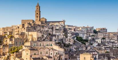 The mountain town of Matera in the region of Basilicata, the setting sun illuminating the town.