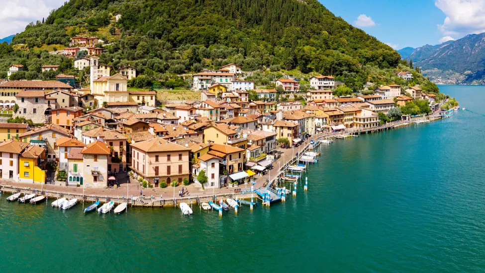 An aerial view of a small town on the coast of Lake Iseo.