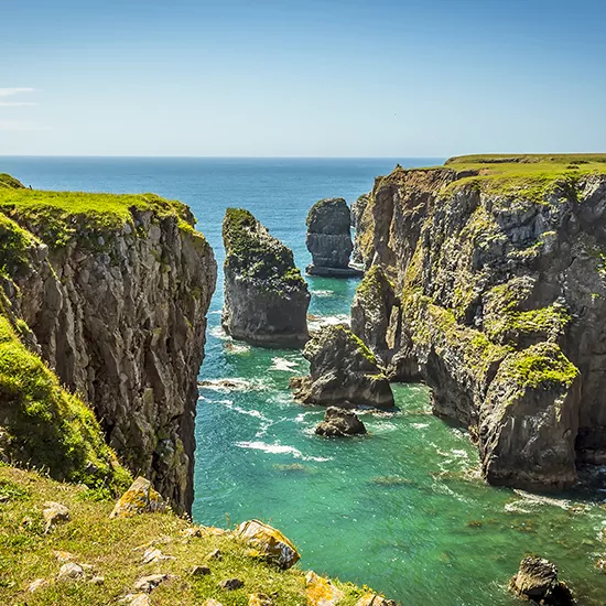 Waves crash against the cliffs along the Pembrokeshire Coastal Walkway.