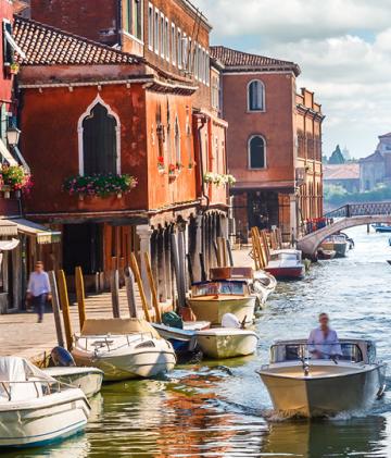 A river boat journeying down the canals of Venice.