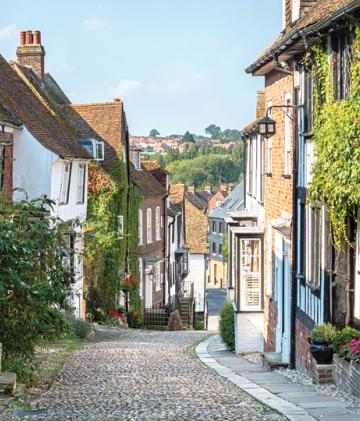 A winding road down a cobbled English village street.