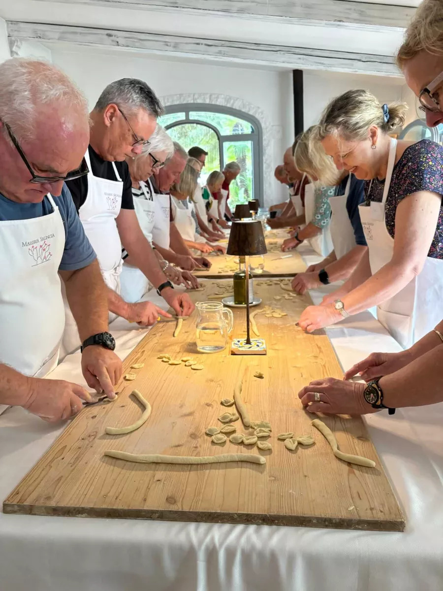 A group taking a pasta lesson